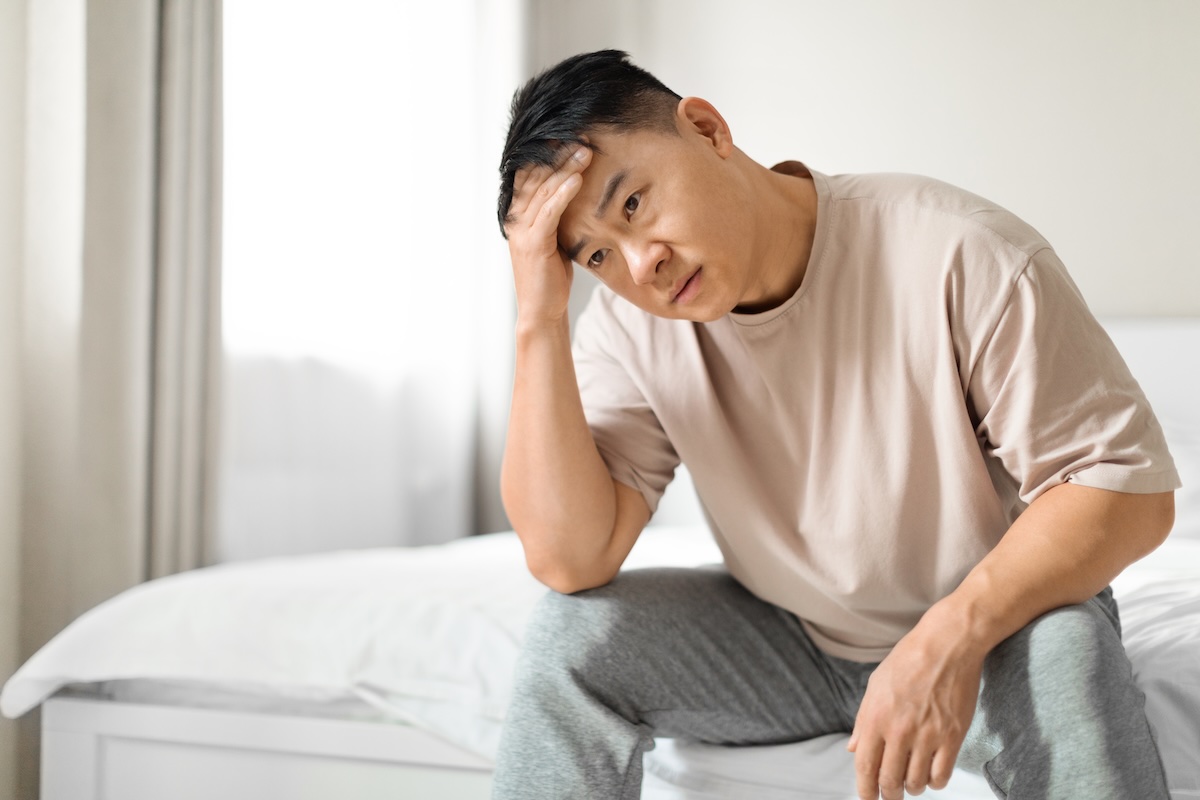 middle aged man experiencing low testosterone symptoms