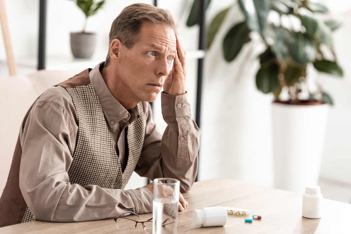 image of a man feeling imbalanced and not well.